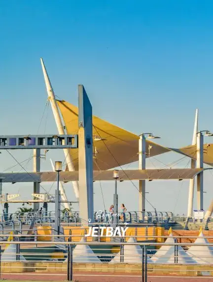 Modern waterfront promenade with golden shade sails and Jetbay branding in Guayaquil, Ecuador