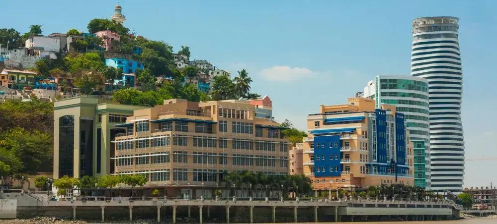 Modern Guayaquil waterfront showcasing contemporary towers and hillside neighborhoods along the Guayas River