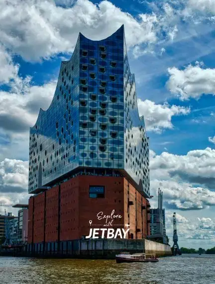 Modern Elbphilharmonie concert hall rising above Hamburg's historic harbor with distinctive glass architecture