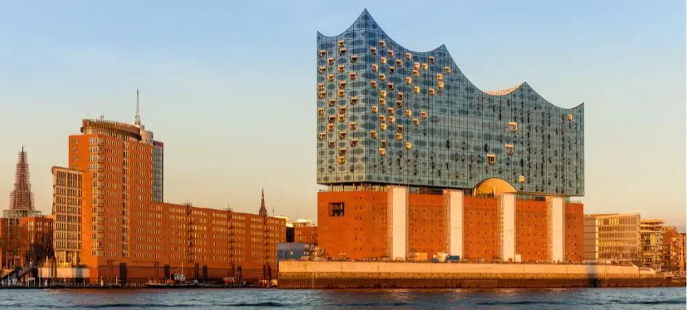 Hamburg's iconic Elbphilharmonie concert hall dominates the waterfront skyline at golden hour