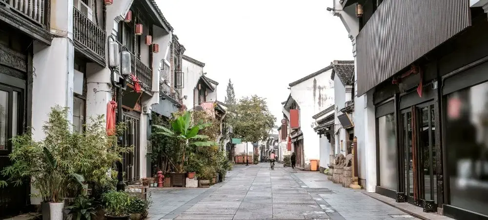 Traditional Chinese street in Hangzhou with historic architecture and stone walkway for luxury travelers