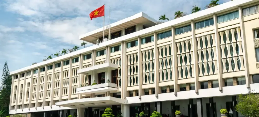 Modern government building with Vietnamese flag in Ho Chi Minh City showcasing contemporary architecture