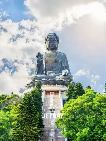 Tian Tan Buddha statue towering majestically above lush green hills in Hong Kong's spiritual landscape