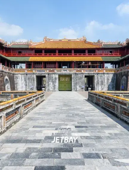 Traditional Vietnamese imperial palace courtyard in Hue with ornate architecture and stone walkway
