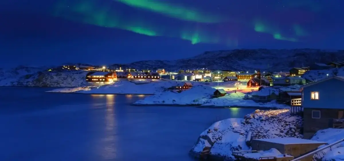Ilulissat skyline and waterfront district photographed from a private aircraft on final approach