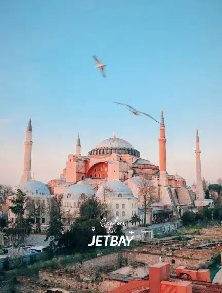 Hagia Sophia's iconic Byzantine dome and Ottoman minarets dominate Istanbul's historic skyline at sunset