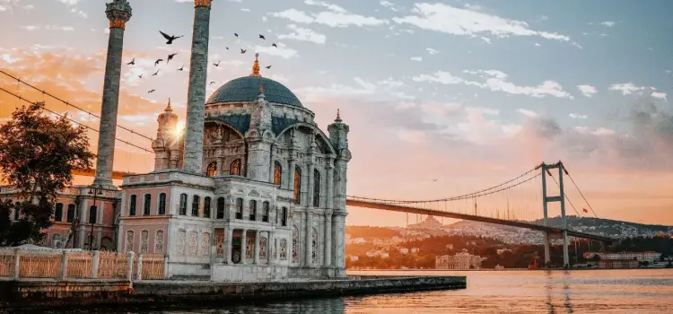 Ortaköy Mosque and Bosphorus Bridge at sunset showcasing Istanbul's iconic waterfront architecture
