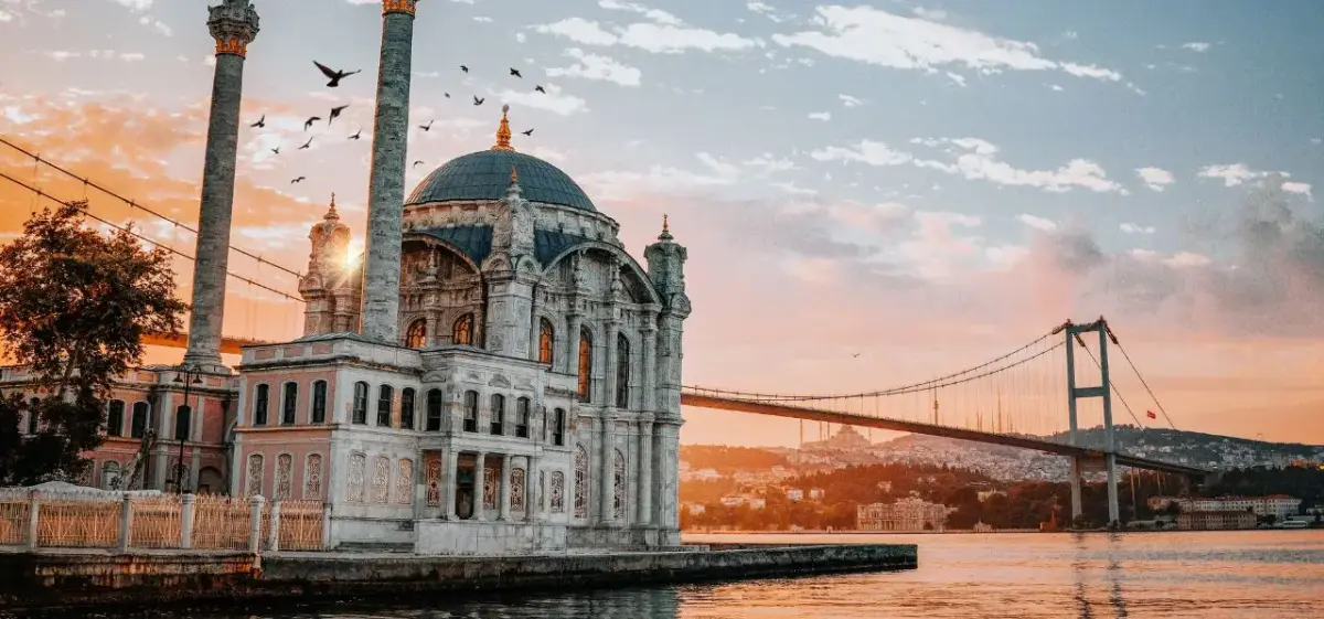 Ortaköy Mosque and Bosphorus Bridge at sunset showcase Istanbul's blend of historic architecture and modern infrastructure