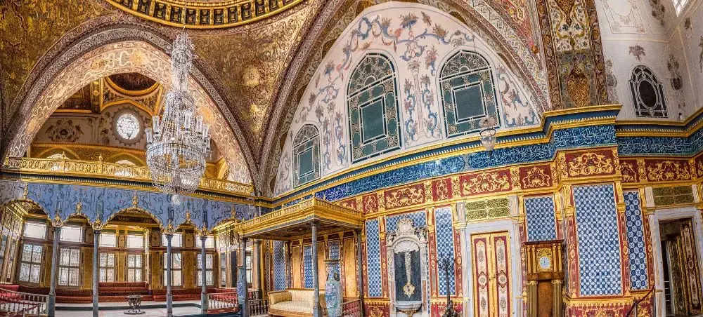 Ornate interior of Topkapi Palace showcasing intricate Ottoman tilework and golden decorative elements in Istanbul