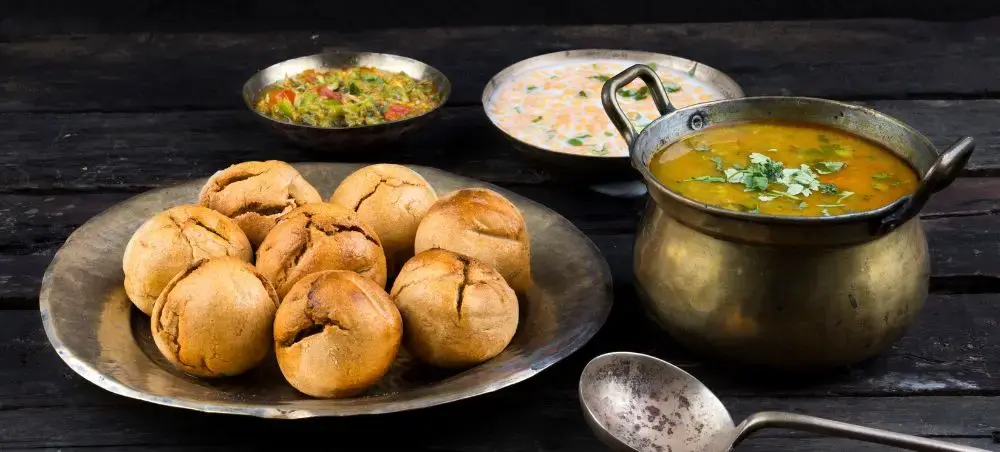 Traditional Rajasthani dal baati churma feast with golden bread rolls and lentil curry in Jaipur