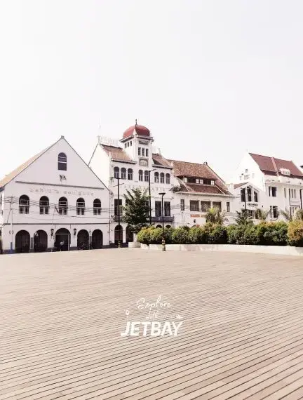 Historic colonial buildings with distinctive architecture surrounding Jakarta's cobblestone town square