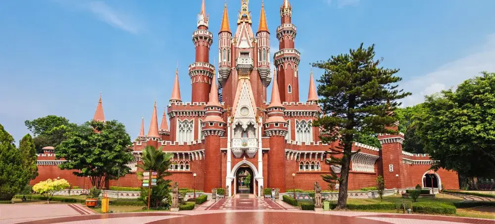 Enchanted Kingdom castle with red brick towers and spires in Jakarta, Indonesia theme park destination