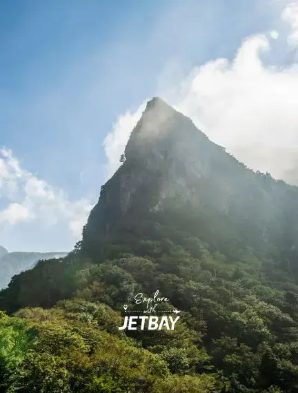 Dramatic volcanic peak rises through misty clouds on Jeju Island, showcasing South Korea's natural beauty