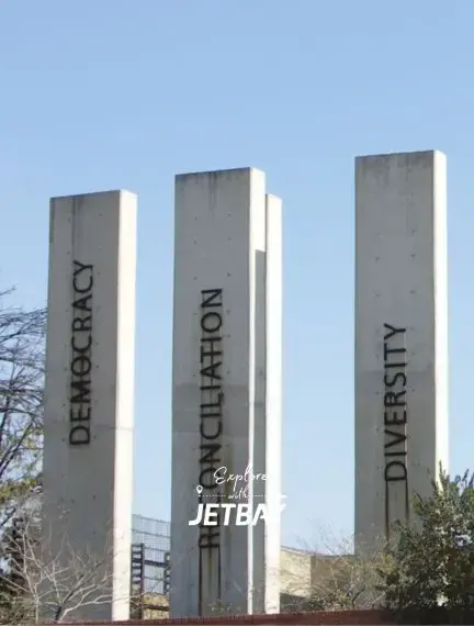Modern concrete pillars displaying Democracy, Constitution, and Diversity values in Johannesburg