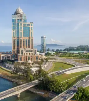 Modern waterfront towers and landscaped grounds showcase Kota Kinabalu's luxury skyline for private jet travelers