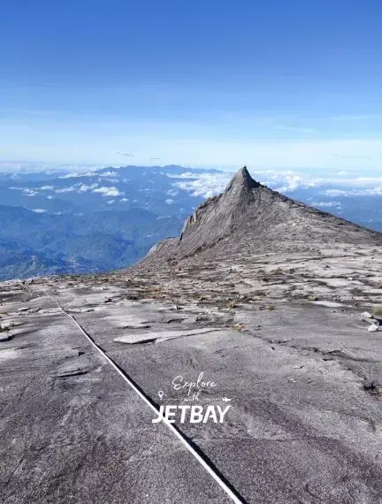 Summit view from Mount Kinabalu peak showing dramatic granite formations and panoramic Malaysian landscape