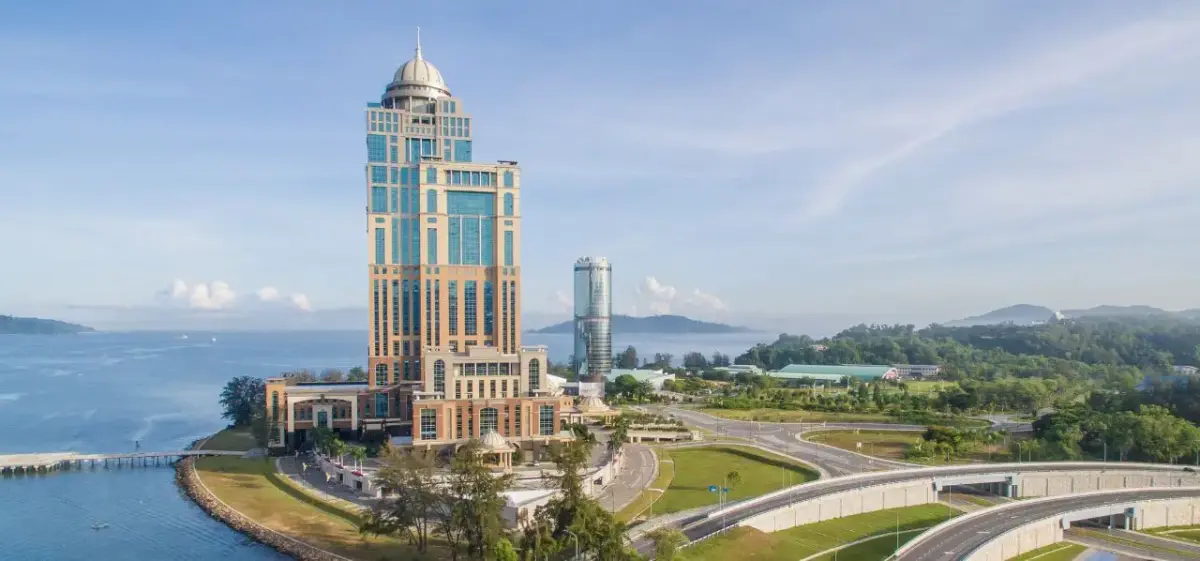 Kota Kinabalu waterfront skyline featuring modern towers and coastal highways overlooking the South China Sea