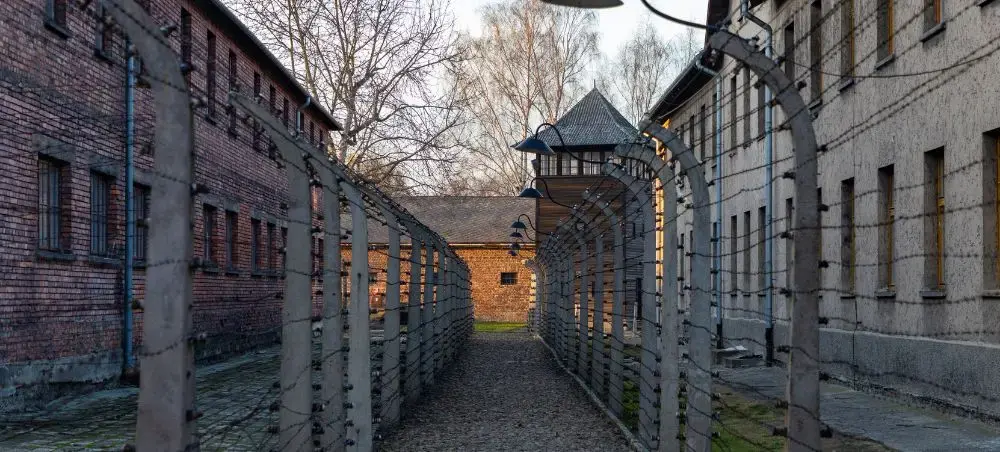 Historic Auschwitz-Birkenau concentration camp memorial site near Krakow with preserved barracks and watchtower