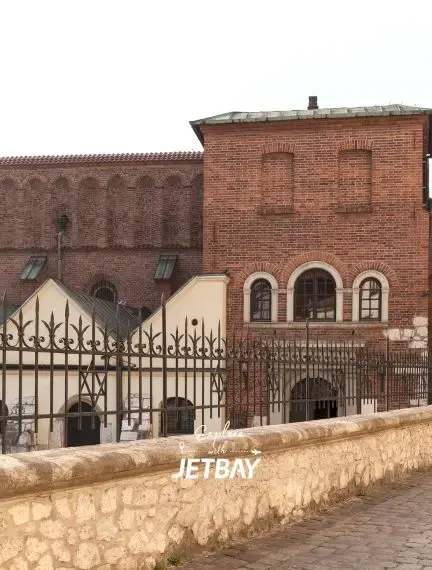 Historic brick buildings and medieval architecture along cobblestone streets in Krakow's Old Town district