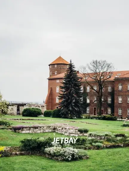 Historic Wawel Castle with medieval tower and manicured gardens in Krakow, Poland's royal district