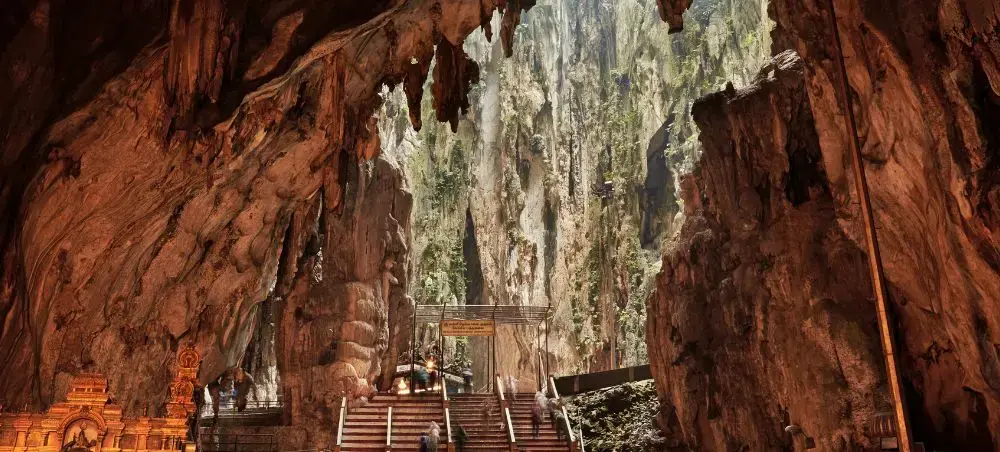 Batu Caves limestone formations with Hindu temple stairs leading to sacred chambers near Kuala Lumpur