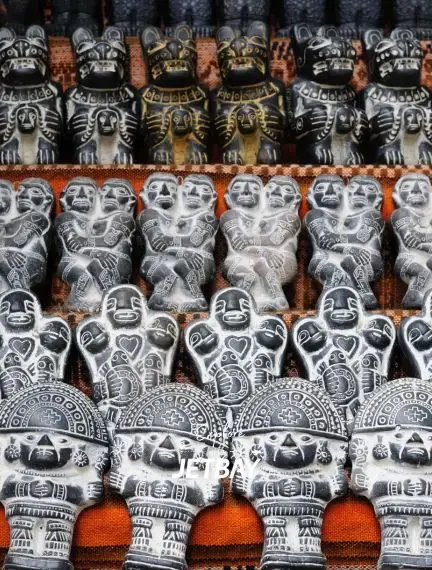 Traditional Bolivian ceramic figurines and masks displayed at La Paz artisan market showcasing local culture