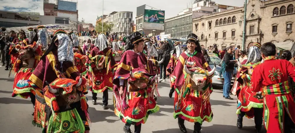 Colorful traditional Bolivian dancers in vibrant costumes performing during cultural festival in La Paz