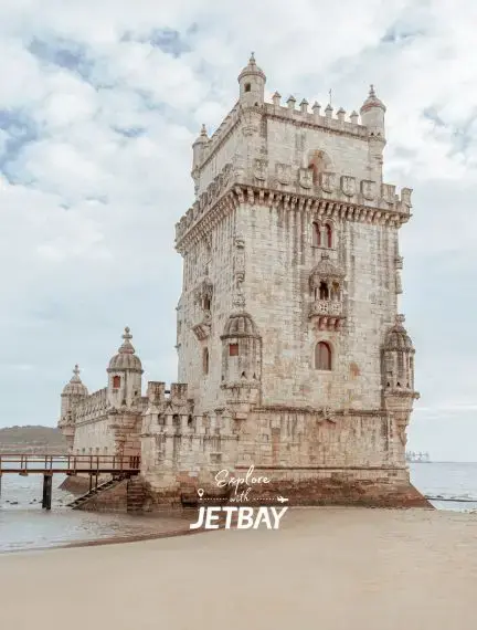 Historic Belém Tower fortress standing in Tagus River waters showcasing Lisbon's maritime heritage