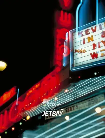 Vintage neon theater marquee illuminates downtown Los Angeles nightlife for luxury travelers