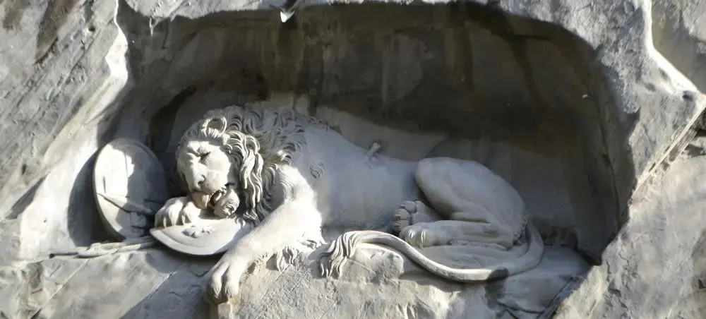 Famous Lion Monument carved into sandstone cliff commemorating Swiss Guards, iconic Lucerne landmark