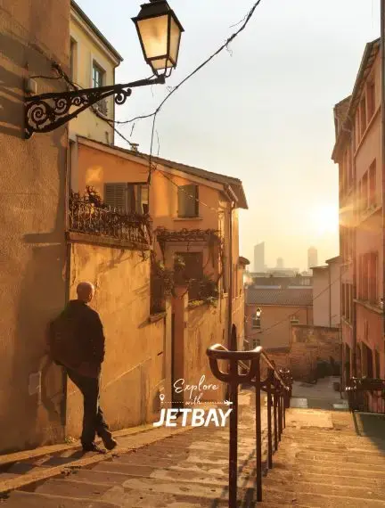 Golden sunset illuminates historic Lyon cobblestone streets with traditional French architecture and vintage streetlamps