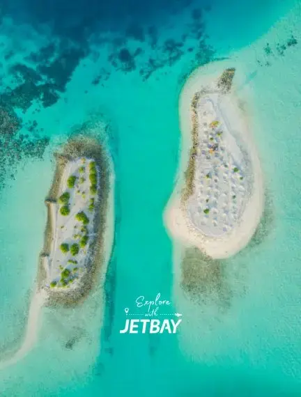 Aerial view of pristine white sand islands surrounded by crystal-clear turquoise waters in the Maldives