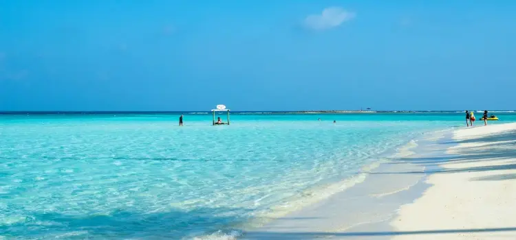 Pristine white sand beach with crystal-clear turquoise waters in Male, Maldives tropical paradise