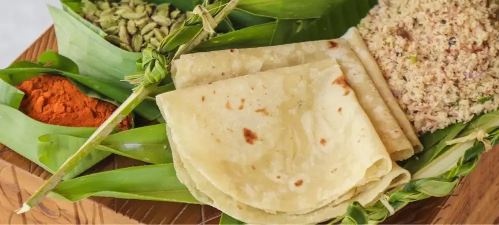 Traditional Maldivian flatbread and spices arranged on wooden platter showcasing authentic Male cuisine