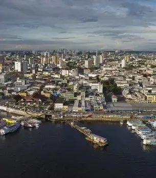 Aerial view of Manaus cityscape with waterfront harbor and boats along the Amazon River in Brazil