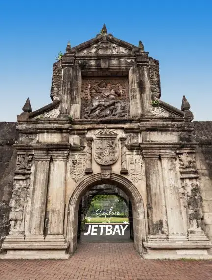 Historic Spanish colonial fortress gate in Manila showcasing ornate baroque architecture and carved stone details