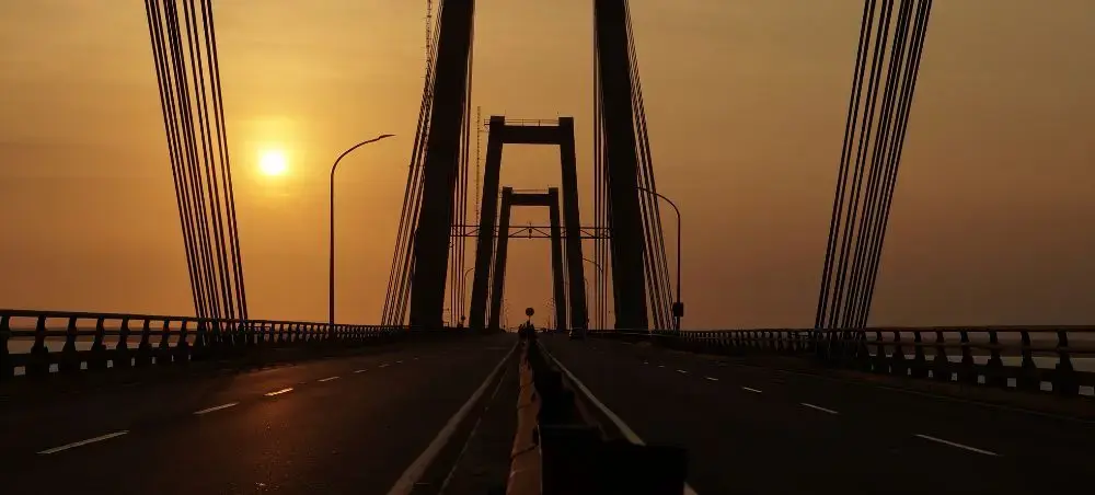 Maracaibo's iconic cable-stayed bridge at golden hour sunset, connecting Venezuela's oil capital across Lake Maracaibo