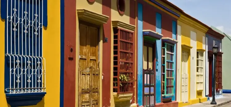Colorful colonial houses with ornate balconies line a historic street in Maracaibo, Venezuela
