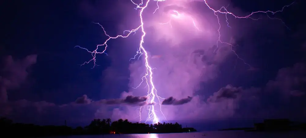 Dramatic lightning strikes illuminate purple storm clouds over Maracaibo Lake in Venezuela at night