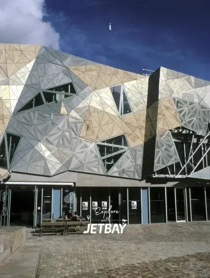 Modern geometric facade of Federation Square cultural precinct in Melbourne's city center under blue sky