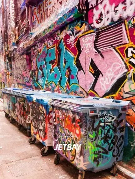 Vibrant street art and graffiti covering walls and dumpsters in Melbourne's famous laneways cultural district