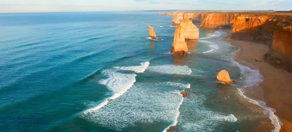 Twelve Apostles limestone stacks rising from turquoise ocean waves along Melbourne's Great Ocean Road coastline