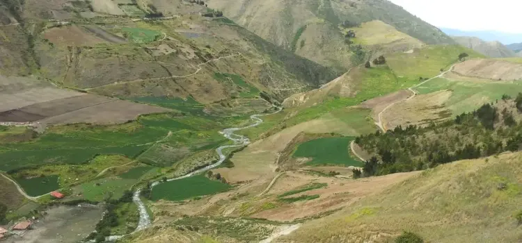 Rolling green valleys and winding river through mountainous terrain of Merida, Venezuela countryside