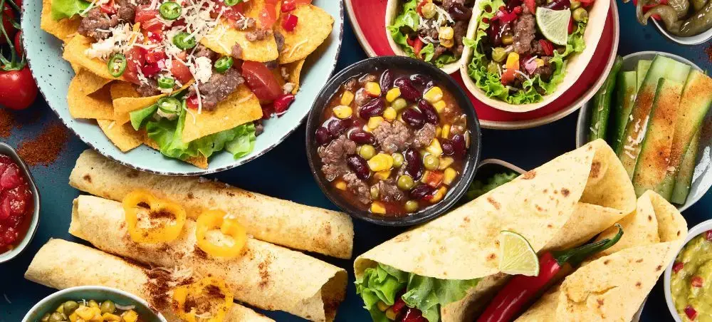 Authentic Mexican cuisine spread featuring tacos, burritos, chili, and fresh salsas showcasing Mexico's culinary heritage