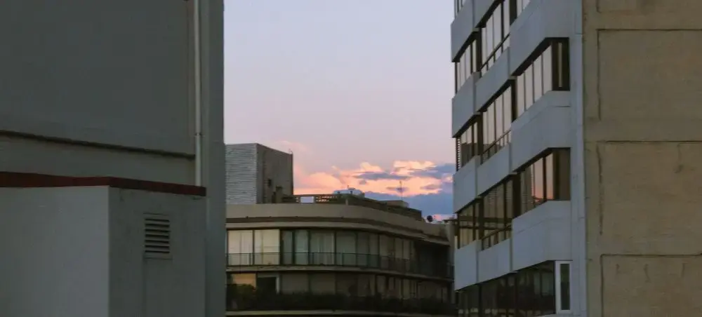Modern Mexico City skyline at dusk with contemporary buildings and warm sunset colors over urban landscape