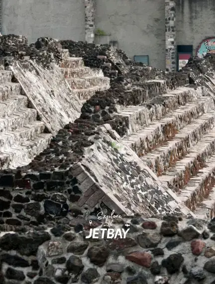 Ancient Aztec temple ruins with stepped stone pyramids at Templo Mayor archaeological site in Mexico City