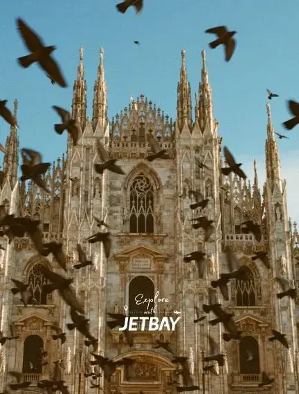 Gothic spires of Milan Cathedral with birds in flight showcasing Italy's architectural masterpiece
