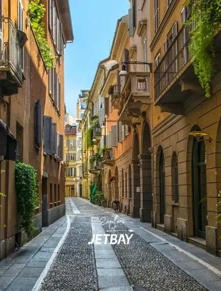 Charming cobblestone street in Milan's historic district with traditional Italian architecture and balconies