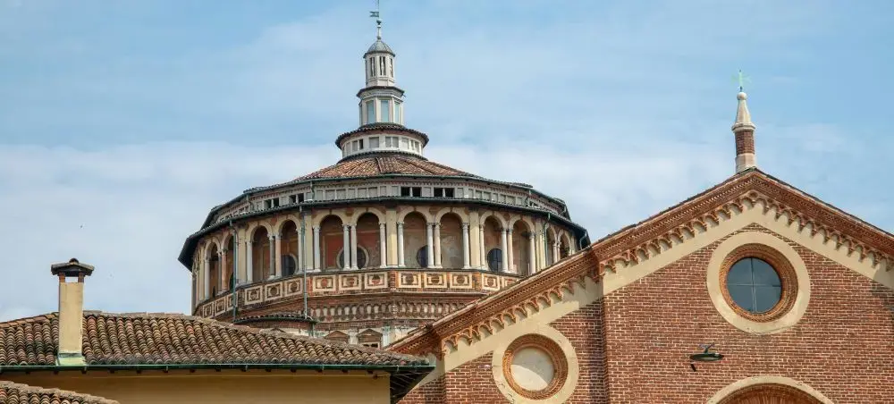 Renaissance dome and brick facade of Santa Maria delle Grazie church in Milan's historic center