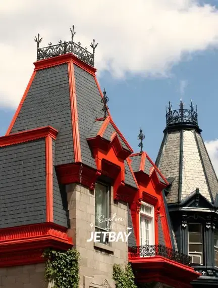 Historic Victorian architecture with ornate red trim and decorative ironwork in Montreal's heritage district